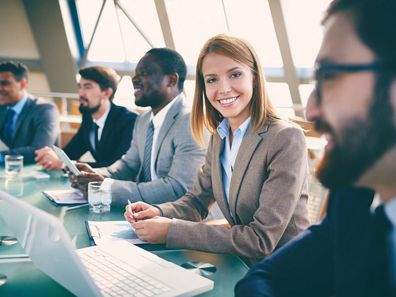 women smiling in business meeting