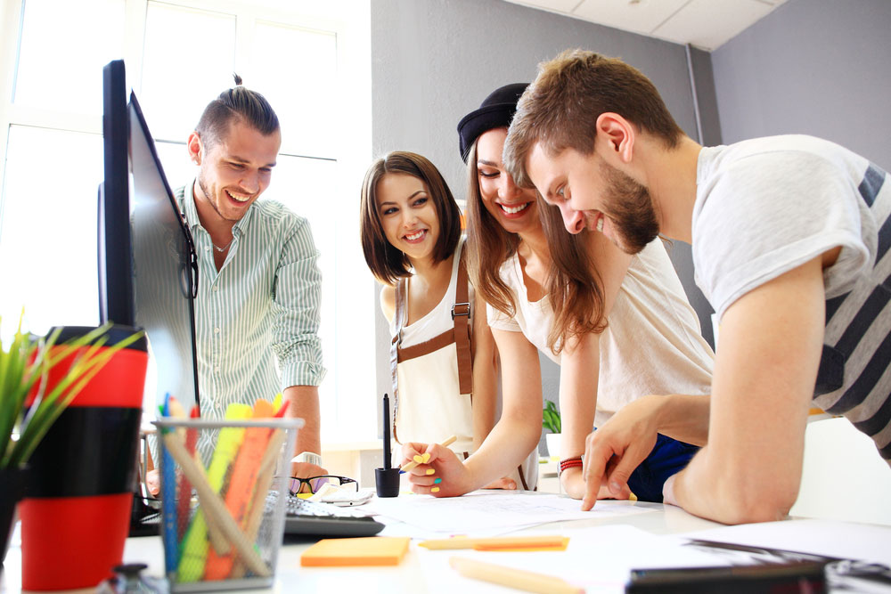 Student workers around a desktop