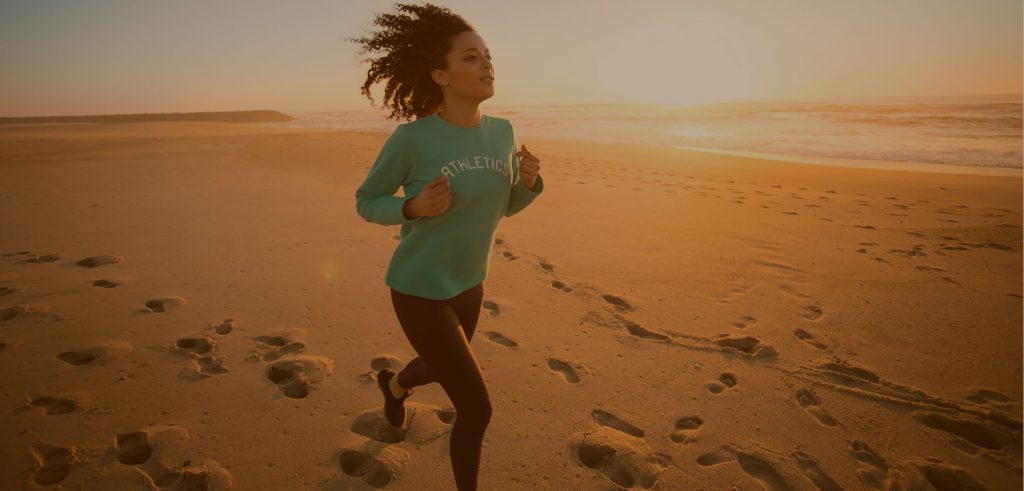 women running on the beach background